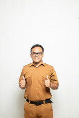 Man in khaki civil servant uniform in indonesia gives thumbs up. Indonesian government worker,...