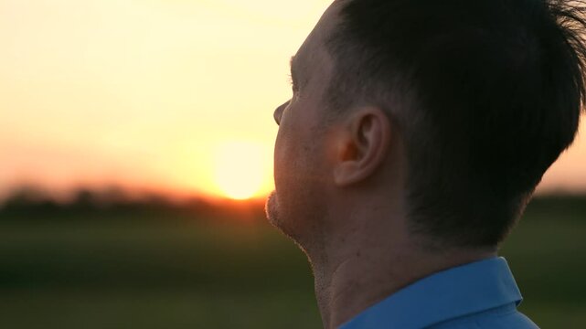 man gazing sunset looking at the sky, silhouette against evening sky man praying god, man look peaceful sunset reflection, serenity nature faith hope, contemplative moment outdoors, enjoying golden