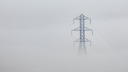 Foggy power lines and pylon.