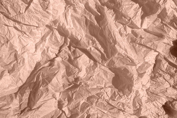 Crumpled kraft paper lies on the surface in mocha mousse color