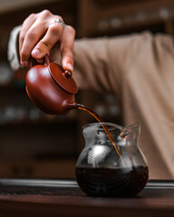 An Artisan Teapot Elegantly Pouring into a Glass Carafe, Creating a Captivating Experience