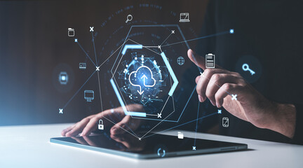 Hands interacting with digital cloud storage icons on a tablet in a futuristic holographic...