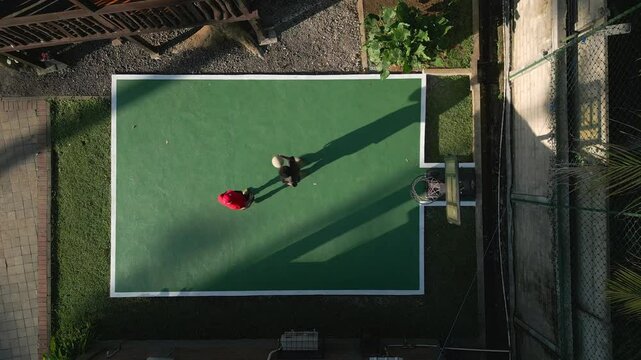 View from the drone to the basketball court. Young guys are playing basketball
