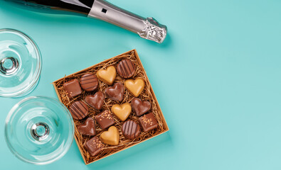 A glasses of champagne elegantly paired with a box of rich chocolates