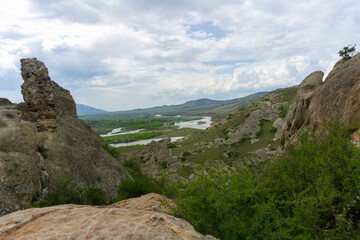 View of the valley, river, village and mountains from the streets of the ancient cave city. Uplistsikhe is an ancient rock-hewn town.