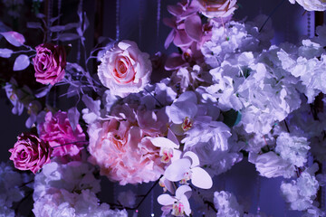 decorative arch decorated with flowers and fabrics. The arch is made in light colors with a predominance of white and pink. The upper part of the arch is decorated with many flowers