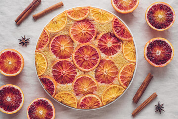 Delisious freshly baked homemade blood orange upside-down cake, top view on neutral background....