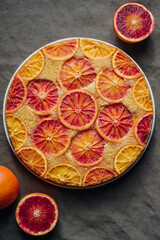 Delisious freshly baked homemade blood orange upside-down cake, top view on grey background....