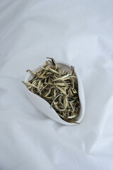 Dried Small Fish Presented Beautifully in an Elegant White Dish for a Tasty Experience