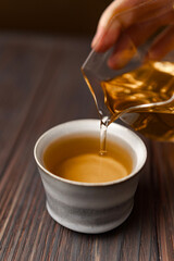 An Elegant and Artful Pouring of Tea into a Beautiful, Traditional and Exquisite Cup