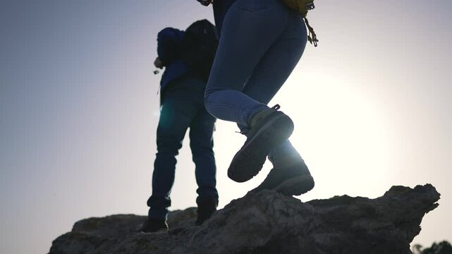 Silhouette of tourists trekking at sunset travel adventure. Sunset hike travel spirit in tourists. Tourists silhouette in sunset travel magical hour. Travel duo in sunset tourists journey culmination.