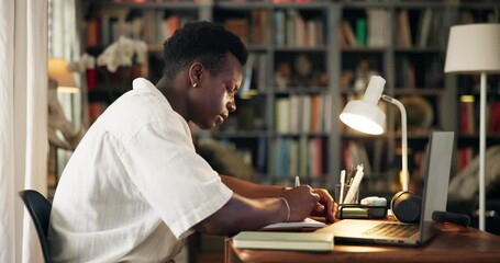 Research, notes and black man in home office with laptop, planning or writing ideas for web article at night. Thinking, journalist or freelance writer at desk with notebook, computer and remote work