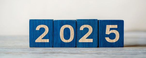 Obraz premium New Year 2025 with Wooden Blocks concept. Blocks displaying the year 2025 on a neutral background.