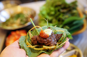 Korean barbecue food. Sesame leaf and meat wrap