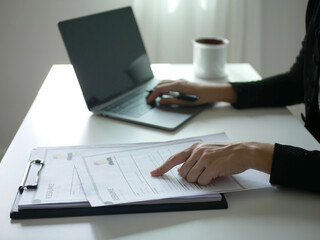 Young businesswoman holds a resume and evaluates it. Views the personal history of job applicants. Recruitment concept