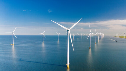 offshore windmill farm in ocean, green energy transition, zero emissions, Windmill turbines generating electric green energy with a blue sky green energy concept in the Netherlands © Fokke Baarssen