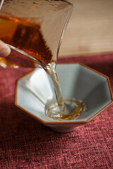 A Beautiful Teapot Gently Pouring Tea into an Exquisite Delicate Ceramic Cup, Celebrating the Art