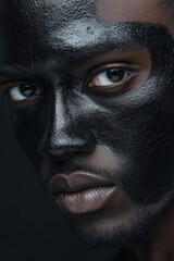 Black History Month theme, close portrait of black skin man with black colour on the face