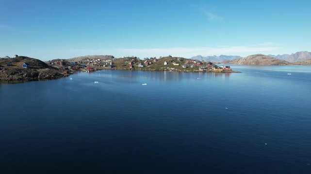 A typical small Inuit village (settlement) in Greenland. Filmed during the summer on a sunny day.
