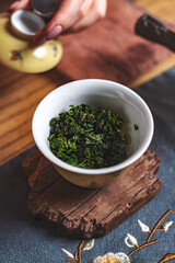 Preparing tea with fresh green leaves in a traditional setting enriches the ambiance
