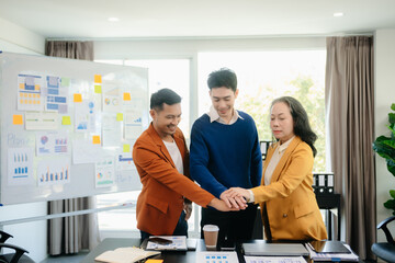 Group of young Asian business people discussing business plan at modern startup