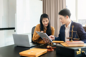 Asian lawyers in a modern office discussing contracts, law, and justice. Collaboration, documents, and determination showcased