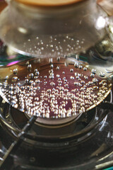 A CloseUp View of Bubbling Water on a Stove Capturing the Dynamic Movement of Liquid