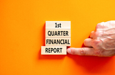 1st quarter financial report symbol. Concept words 1st quarter financial report on beautiful wooden blocks. Beautiful orange background. Business 1st quarter financial report concept. Copy space.