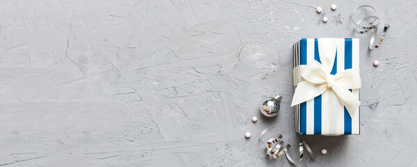 Top view Flat lay Christmas decorations and gift box on colored background with copy space. Christmas or Happy New Year composition