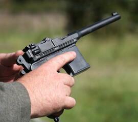 Cocking action of small military pistol sidearm.
