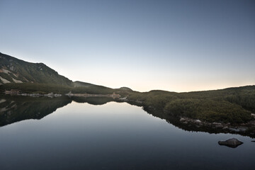 A mountain peak in the High Tatras with a pond at its foot. Mountain landscape.
