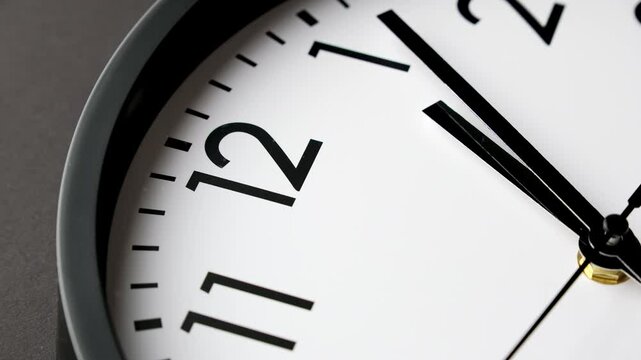 Clock running fast. Time lapse of black and white classic wall clock. Start time 12.45. Time passing 30 minutes. Analog wall clock. Timelapse. Time concept. Close-up in 4K, UHD