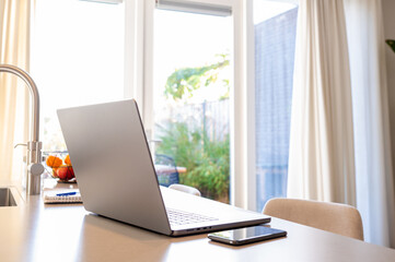 laptop on the kitchen counter at home.