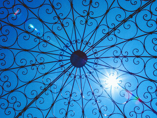 old metal gazebo with swirl pattern