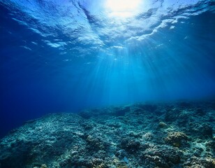 Obraz premium A stunning underwater scene with blue sunlight piercing the deep-sea abyss, creating tranquil patterns, ideal for marine-themed or nature-inspired visuals