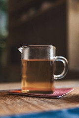 An Elegant Glass Teapot Resting on a Wooden Surface in a Cozy and Inviting Setting