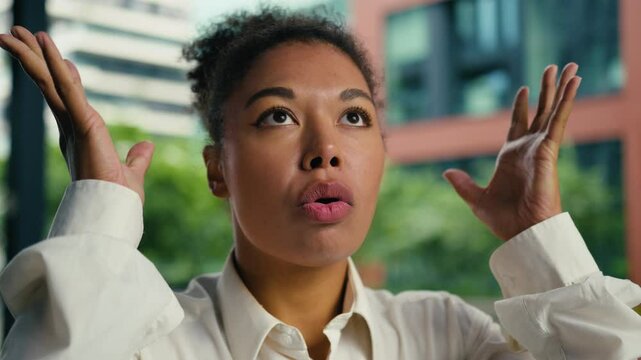 Excited African American woman surprised wow businesswoman showing hands female brain explosion head mind blow girl emotions shocked shock news overload gesture headshot city business crazy outside