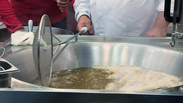 Close-up of preparing a traditional Spanish sweet called Churros. High quality 4k footage