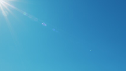 Fototapeta premium Sun Shining Bright In Clear Blue Sky. Solar Energy Power Concept Of Natural Bright Sun Light Ray. Tropical Summer Sunlight. Atmosphere And Ozone Layer.