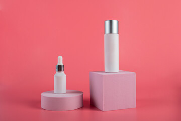 Plastic white tube for cream or lotion. Skin care or sunscreen cosmetic with stylish props on pink background.