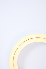 Flexible warm white led tape glowing on white background.