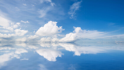 Obraz premium Blue Sky and Clouds Reflecting in Water and Copy Space