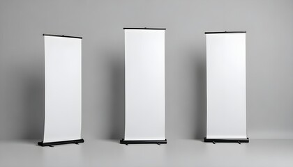Three blank white roll-up banners on a gray background
