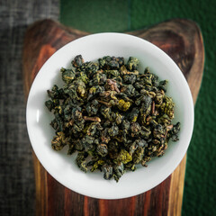 Oolong Tea Leaves are Beautifully Arranged Neatly in a Bowl on a Rustic Wooden Surface