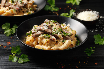Philly cheese steak pasta in black bowl