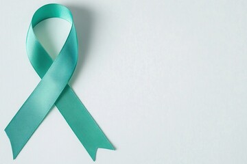 Green satin ribbon placed on the side of the image. Awareness month on brain injuries.