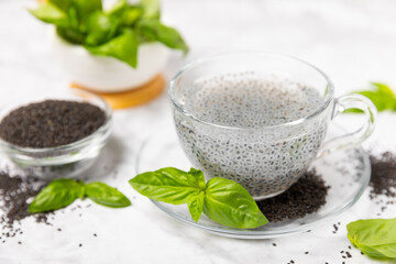 Basil seeds on textured wooden background. Close-up. Superfood. Ocimum basilicum. Organic basil seeds. selasih. Space for text. Copy space.