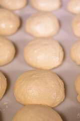 round buns made of white flour dough, baking preparation