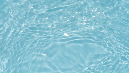 Blue water with ripples on the surface. Defocus blurred transparent blue colored clear calm water surface texture with splashes and bubbles. Water waves with shining pattern texture background.