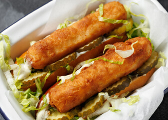 Fish finger hot dogs with gherkin and tartar sauce